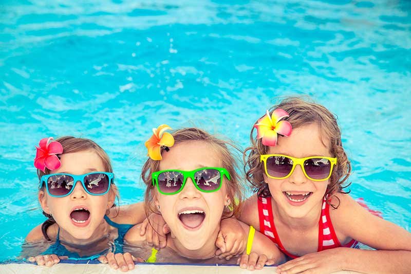 3 adorable girls swimming at Highland Family Aquatic Center in Pinellas Park